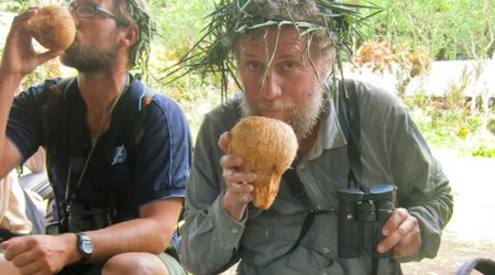 The author enjoying coconut milk and showing off his favorite binoculars. Nendö Island, Santa Cruz Island, Solomons.